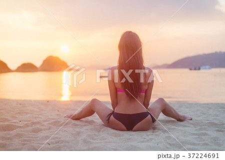 Back view of young female with long brown hair Back view of young female with long brown hair 37224691