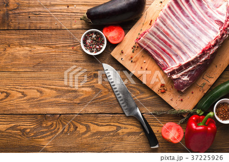 Raw rack of lamb on wooden board Raw rack of lamb on wooden board 37225926