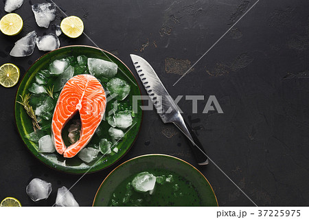 Fresh salmon in green plate at dark background 37225975
