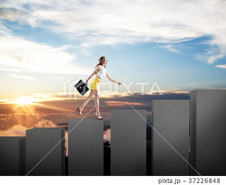 Young business woman climbs up on cubes staircase. 37226848