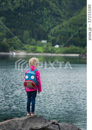 little blonde girl at the shore of norwegian lake little blonde girl at the shore of norwegian lake 37233380