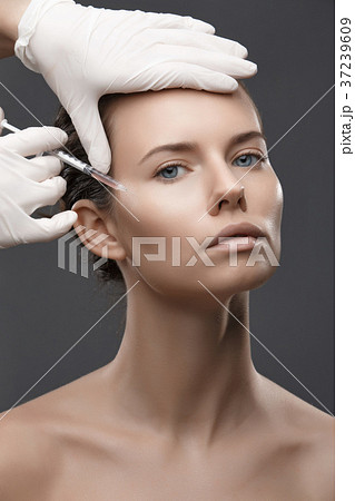 Portrait of young Caucasian woman getting cosmetic Portrait of young Caucasian woman getting cosmetic 37239609