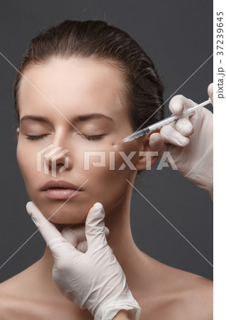 Portrait of young Caucasian woman getting cosmetic 37239645