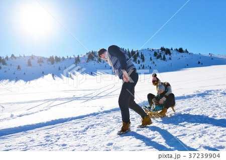 happy young family playing in fresh snow at happy young family playing in fresh snow at 37239904