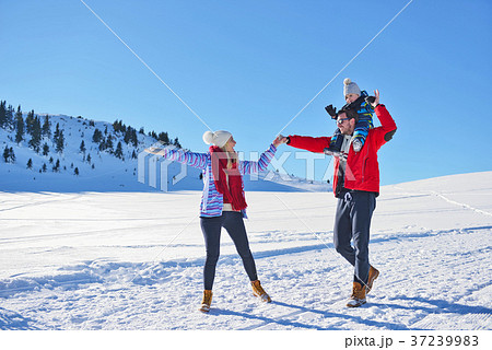 happy young family playing in fresh snow at 37239983
