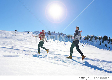Couple having fun running down slope Couple having fun running down slope 37240067