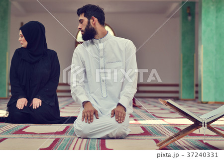 Muslim man and woman praying in mosque Muslim man and woman praying in mosque 37240331