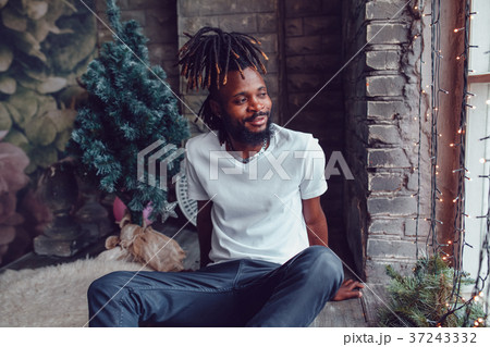 African American man with dreadlocks and a white T 37243332