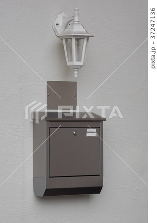 A silver mailbox on the wall 37247136