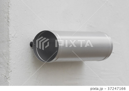 A silver box for newspapers on the wall 37247166