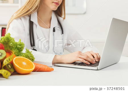 Female nutritionist working on laptop Female nutritionist working on laptop 37248501