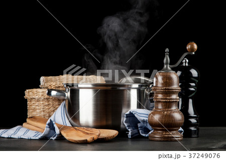 Steaming pot on black background 37249076