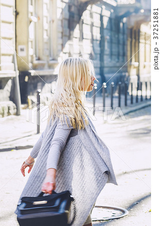 Young stylish woman walking on the city street Young stylish woman walking on the city street 37251881