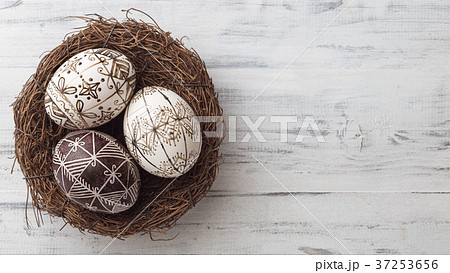 Easter eggs in the nest on wooden background 37253656