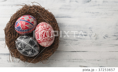 Easter eggs in the nest on wooden background 37253657