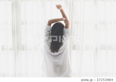 Asian girl stretching near a window Asian girl stretching near a window 37253964