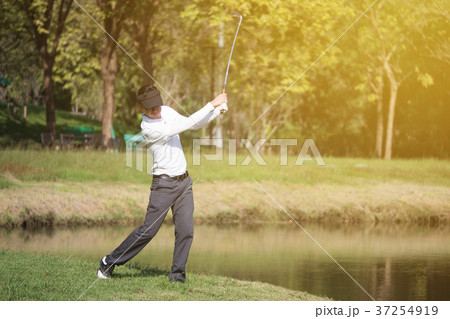 golf player swinging driver golf club  37254919