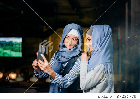 Two Muslim woman friend selfie by smartphone Two Muslim woman friend selfie by smartphone 37255779