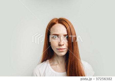 redhead girl with healthy freckled skin looking at 37256382