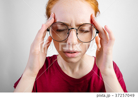 female has headache, keeps hand on temples, feels female has headache, keeps hand on temples, feels 37257049
