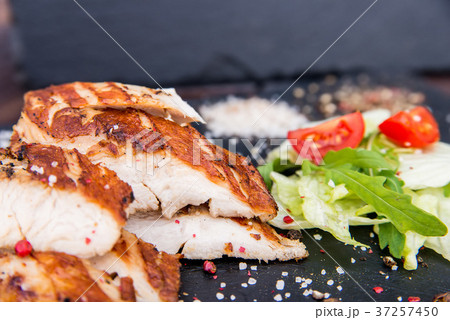Grilled turkey fillet and vegetables in restaurant 37257450