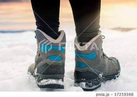 Person hiking on the mountaintop covered with snow Person hiking on the mountaintop covered with snow 37259366