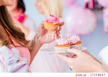 Expecting mother eating cupcake on baby shower Expecting mother eating cupcake on baby shower 37259647