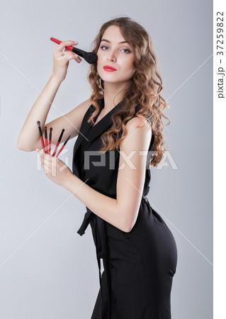 woman make-up artist with natural make-up holding woman make-up artist with natural make-up holding 37259822