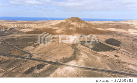Aerial view of desert road volcano panorama by sea 37260282