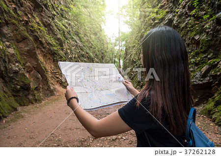 Back side of young traveler see the map in the deep forest, Hellfire Pass at kanchanaburi, Thailand, Travel and transportation concept 37262128