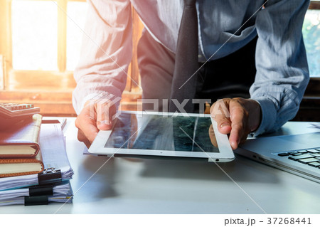 Businessman working with tablet Businessman working with tablet 37268441