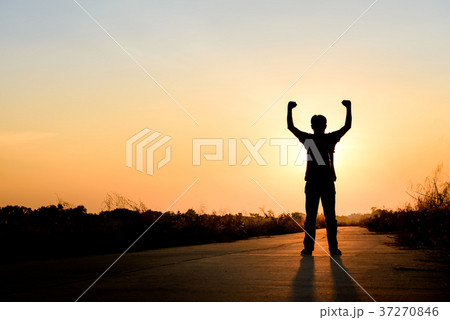 man standing on road at sunset background man standing on road at sunset background 37270846