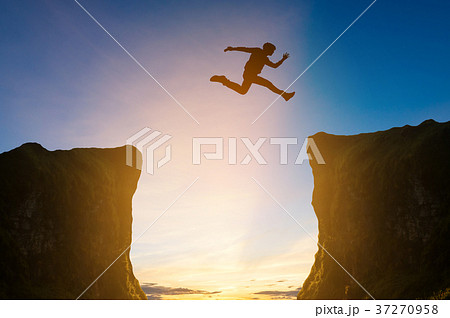 man jumping over the cliff, silhouette man jumping over the cliff, silhouette 37270958