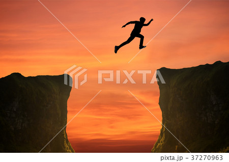 man jumping over the cliff, silhouette man jumping over the cliff, silhouette 37270963