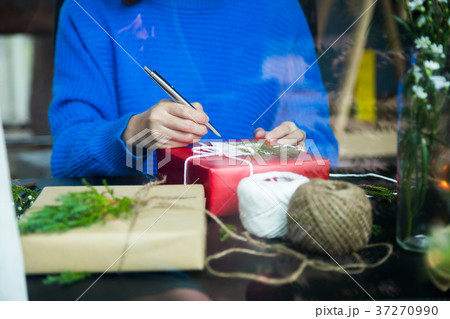 Write message in a card with present for festival 37270990