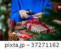 Cutting red ribbon for wrapping present 37271162