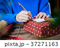 Writing message in a card and giving present 37271163