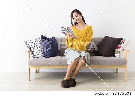 ソファに座るミドル女性の写真素材
