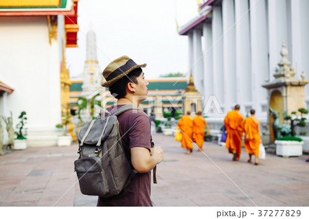 Young Asian traveling tourist with Buddhist monks 37277829