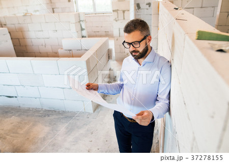 Architect or home owner at the construction site. Architect or home owner at the construction site. 37278155