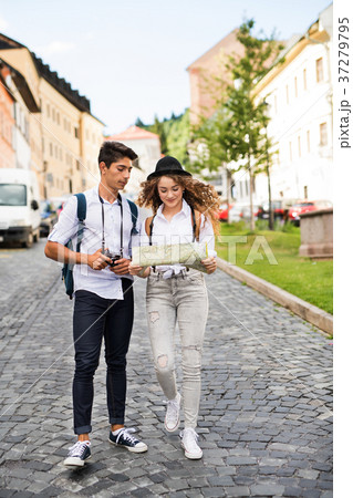 Two young tourists with map and camera in the old Two young tourists with map and camera in the old 37279795