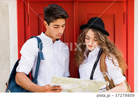 Two young tourists with map in the old town Two young tourists with map in the old town 37279809