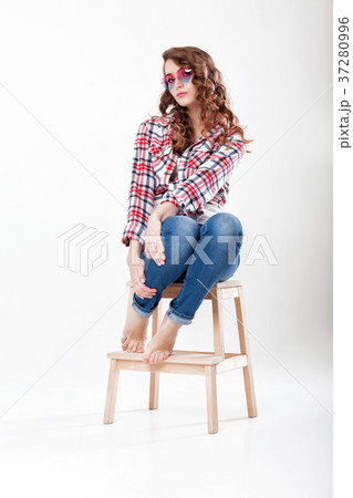 woman in jeans, plaid shirt and sunglasses 37280996