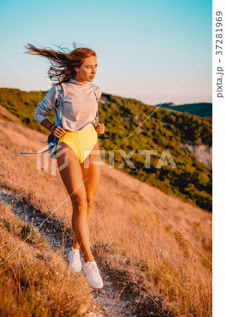 Beautiful sporty woman in nature at warm sunset Beautiful sporty woman in nature at warm sunset 37281969