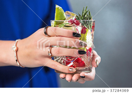 The exotic cocktail and female hands 37284369