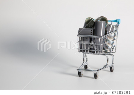 Shopping trolley andunrolled exposed film strips 37285291