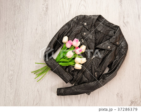 Fashionable concept. Black leather jackets, tulips Fashionable concept. Black leather jackets, tulips 37286379