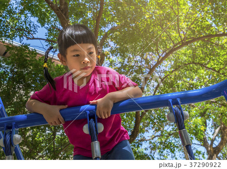 Happy little girl climbing on outdoor playground 37290922
