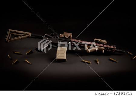 assault rifle and golden bullets on a black background assault rifle and golden bullets on a black background 37291715