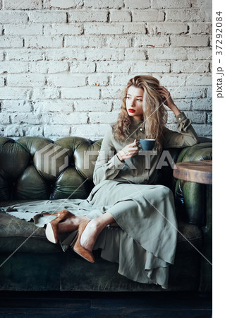 young beautiful woman sitting on a couch 37292084